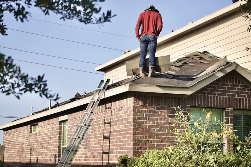 Professional roofer working on a residential roof in Piketown